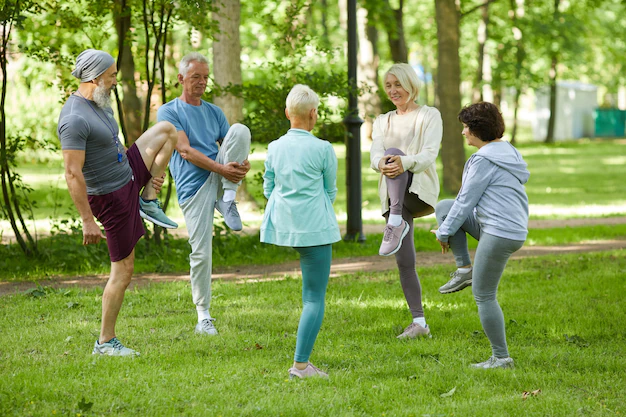 group-modern-senior-people-spending-sunny-morning-park-doing-stretching-exercise_